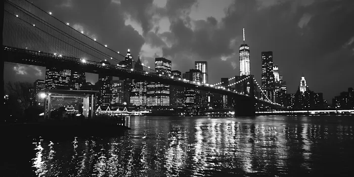 New York City Skyline with Brooklyn Bridge in Foreground, at Night