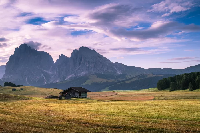 A picturesque landscape with a wooden cabin
