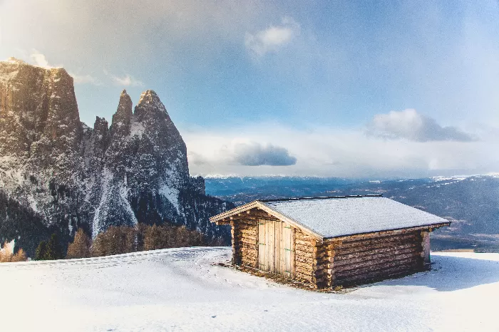 Wooden house covered in snow