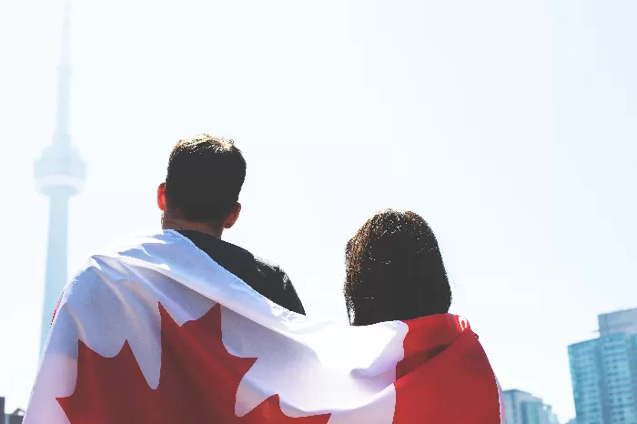 Man and woman wrapped in Canadian flag