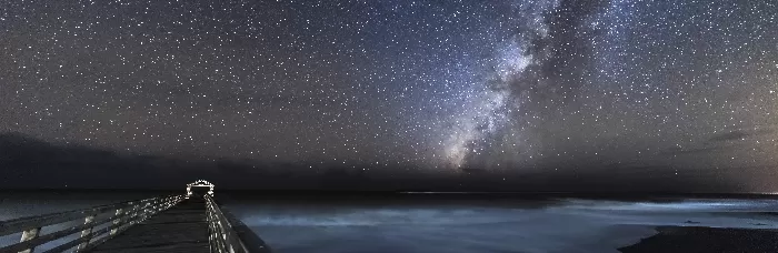 The Milky Way crossing the night sky at Waimea State Recreation Pier in Hawaii